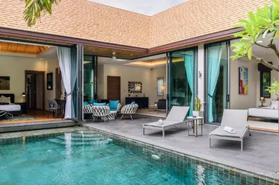 a villa with a swimming pool and a patio at Inspire Villas Phuket in Rawai Beach