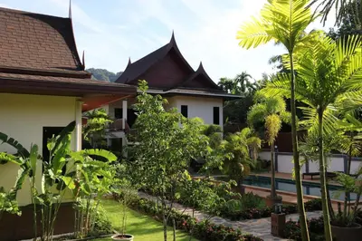 a view of the courtyard of a house with trees at Chanapha Residence in Tab Kaek Beach