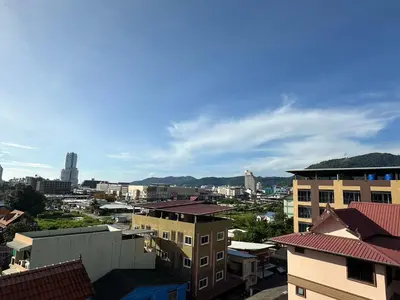 a view of a city with buildings and mountains at Baan Kingkeaw Thamdee Patong in Patong Beach