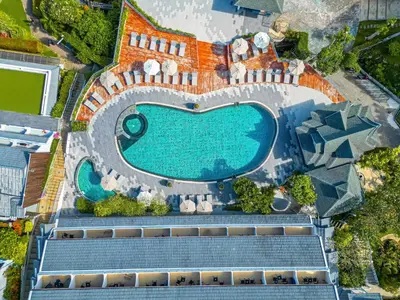 an overhead view of a swimming pool with a resort at Orchidacea Resort - Kata Beach in Kata Beach