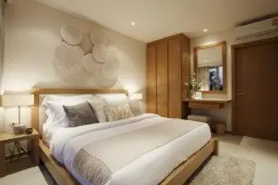 a bedroom with a large bed in a room at Trichada Villas by RESAVA in Bang Tao Beach