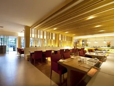 a dining room with tables and chairs in a restaurant at Phuket Graceland Resort and Spa in Patong Beach