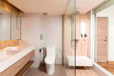 a bathroom with a toilet and a sink and a shower at Phuket Graceland Resort and Spa in Patong Beach