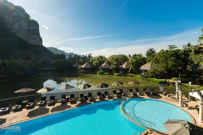 a view of the pool at a resort with chairs and a lake at Peace Laguna Resort & Spa in Ao Nang Beach
