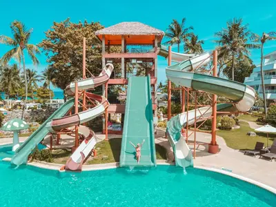 a water slide in a pool at a resort at Thavorn Palm Beach Resort Phuket in Karon Beach