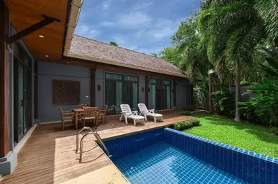 a house with a pool and a patio with a table and chairs at VILLA FLORES 3BR Private Pool 10 min to Nai Harn in Rawai Beach