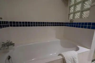 a white bath tub in a bathroom with a mirror at Kantary Bay Hotel Phuket in Panwa Beach