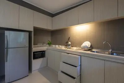 a kitchen with a sink and a refrigerator at Kantary Bay Hotel Phuket in Panwa Beach