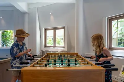 two people standing next to a giant chessboard at Cape Panwa Hotel Phuket in Panwa Beach