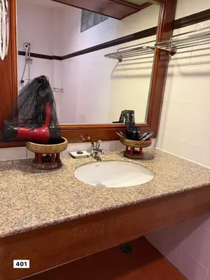 a bathroom counter with a sink and a mirror at Royal Phawadee Village Patong - 2 Minutes walk to the beach in Patong Beach