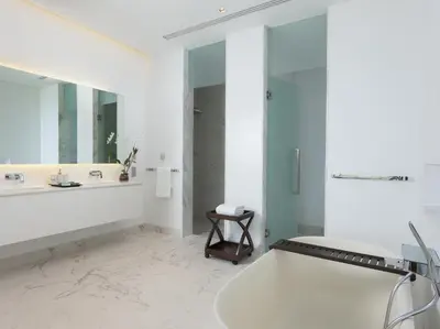 a white bathroom with a tub and a sink at Malaiwana Residences in Nai Thon Beach