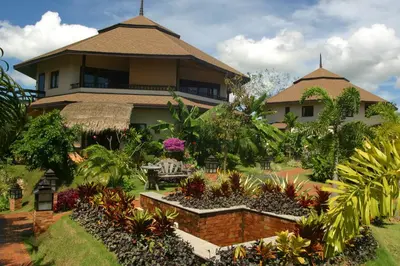 a house with a garden in front of it at Mangosteen Ayurveda & Wellness Resort - SHA Plus in Rawai Beach