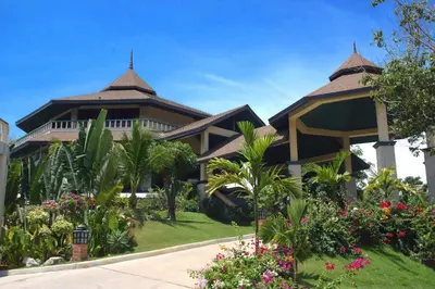 a house with a garden in front of it at Mangosteen Ayurveda & Wellness Resort - SHA Plus in Rawai Beach