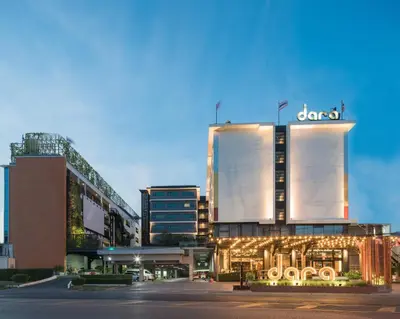 a building with a sign on the side of it at DARA Hotel in Phuket Town
