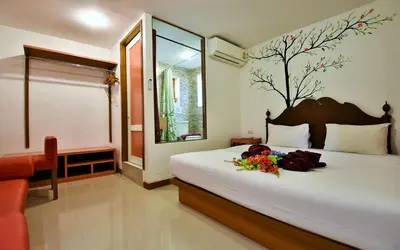 a bedroom with a bed with flowers on it at Phi Phi Arboreal Resort in Phi Phi Don
