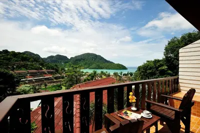 a balcony with a table and a view of the water at Phi Phi Arboreal Resort in Phi Phi Don