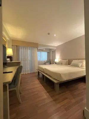 a bedroom with a large bed and a desk at Aonang All Seasons Beach Resort in Ao Nang Beach