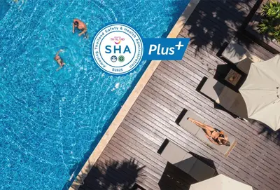 an overhead view of two people swimming in a swimming pool at Baan Laimai Beach Resort & Spa - SHA Extra Plus in Patong Beach