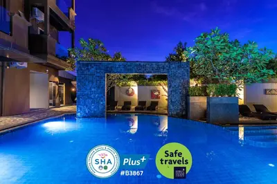 a swimming pool in a hotel at night at Mazi Design Hotel by Kalima in Patong Beach
