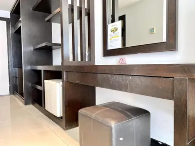 a bathroom with a mirror and a trash can at APK Resort Patong in Patong Beach