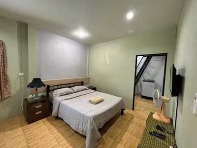 a bedroom with a large bed and a mirror at The Endless Bangtao Residence LOFT 8 in Bang Tao Beach