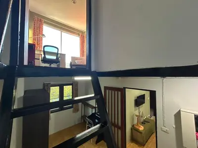 two images of a room with a staircase and a living room at The Endless Bangtao Residence LOFT 8 in Bang Tao Beach