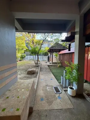 a walkway leading into a building with plants in a yard at The Endless Bangtao Residence LOFT 8 in Bang Tao Beach