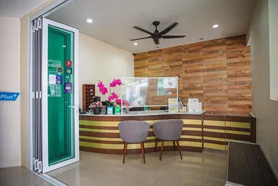 a kitchen with two chairs and a counter with a fish tank at Capricorn Village - SHA Extra Plus in Patong Beach