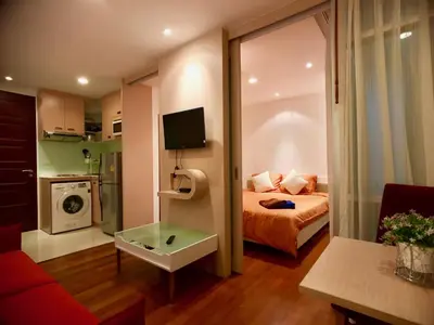 a small room with a bed and a living room at Art Patong by Moloko in Patong Beach