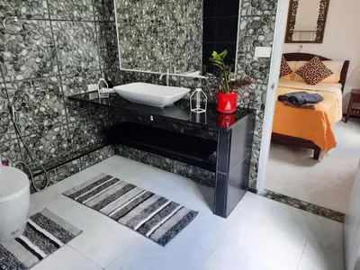 a bathroom with a sink and a mirror at Bjou, Cosy Tropical Villa in Rawai Beach