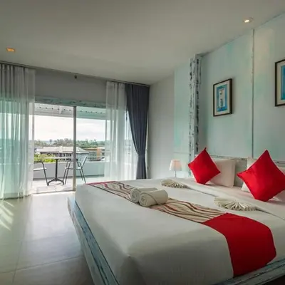 a bedroom with a large bed with red pillows at Baan Ban Dalay in Ao Nang Beach
