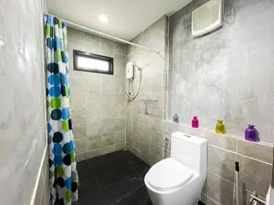 a bathroom with a toilet and a shower at The Endless Bangtao Residence LOFT 9 in Bang Tao Beach