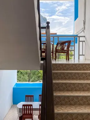 a view from the balcony of a house with a table and chairs at The Palace Aonang Resort in Ao Nang Beach