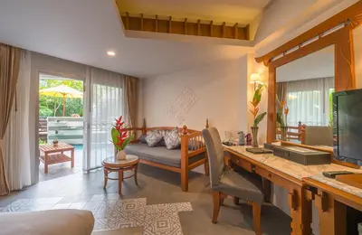 a living room with a desk and a couch at Aonang Princeville Villa Resort & Spa - GHA WellHotel-Halal Certified, Krabi, Thailand in Ao Nang Beach