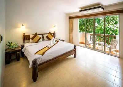 a bedroom with a bed and a large window at Aonang Sunset Hotel - SHA Extra Plus in Ao Nang Beach