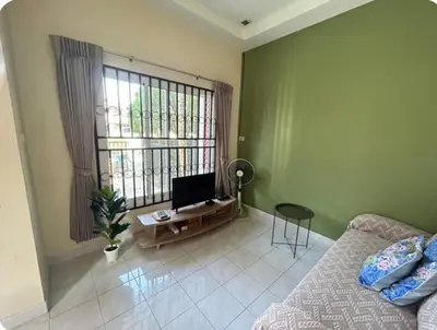 a bedroom with a bed and a tv and a window at The Endless Bangtao Residence TV2 AND TV 3 in Bang Tao Beach