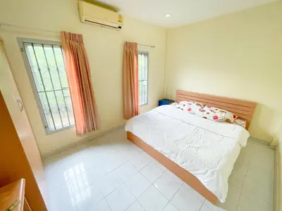a bedroom with a bed and a window at The Endless Bangtao Residence TV2 AND TV 3 in Bang Tao Beach