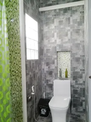 a bathroom with a white toilet and a shower at The Endless Bangtao Residence CAC 4 in Bang Tao Beach