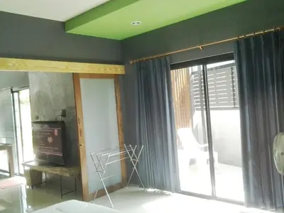 a living room with a tv and a window at The Endless Bangtao Residence CAC 4 in Bang Tao Beach