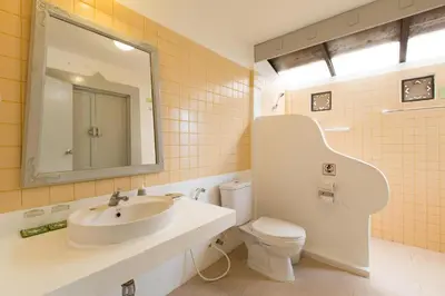 a bathroom with a sink and a toilet and a mirror at Bayview Resort Phi Phi Island - Beach Front Resort in Phi Phi Don
