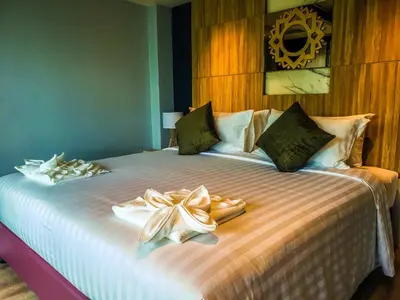 a bedroom with a bed with two towels on it at Niramaya Villa & Wellness in Ko Yao Noi