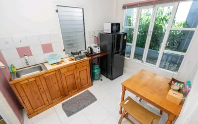 a kitchen with a black refrigerator and a table at The Endless Bangtao Residence ST2 in Bang Tao Beach