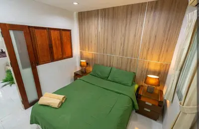 a small bedroom with a green bed in it at The Endless Bangtao Residence ST2 in Bang Tao Beach