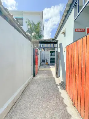 a hallway of a house with a gate and a palm tree at The Endless Bangtao Residence ST2 in Bang Tao Beach