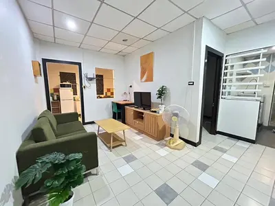 a living room with a couch and a desk with a fan at The Endless Bangtao Residence CAC 2 in Bang Tao Beach