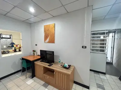 an office with a desk and a tv on a wall at The Endless Bangtao Residence CAC 2 in Bang Tao Beach