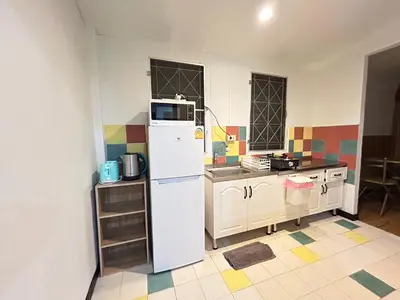 a kitchen with a white refrigerator and a microwave at The Endless Bangtao Residence CAC 2 in Bang Tao Beach