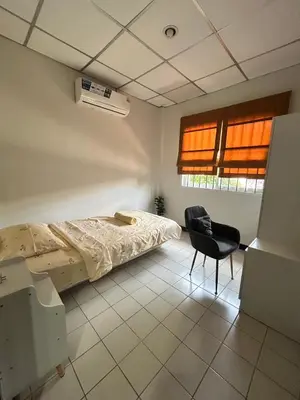 a bedroom with a bed and a chair in it at The Endless Bangtao Residence CAC 2 in Bang Tao Beach