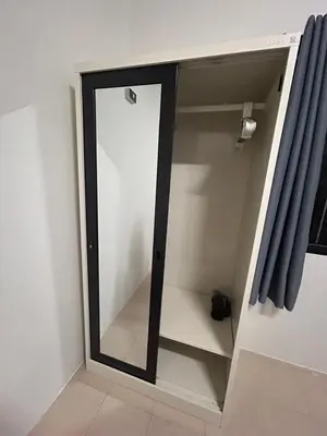 a mirror in the corner of a room with a window at The Endless Bangtao Residence PM12 in Bang Tao Beach