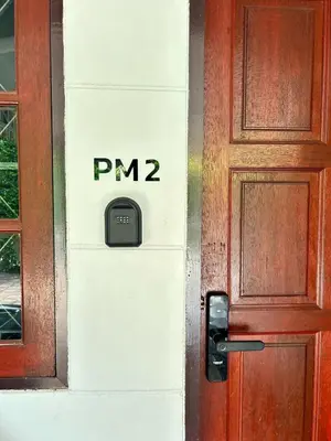 a door with a mailbox on the side of a building at The Endless Bangtao Residence PM12 in Bang Tao Beach